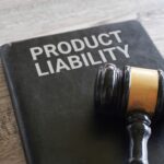 Closeup image of judge gavel and text product liability on table