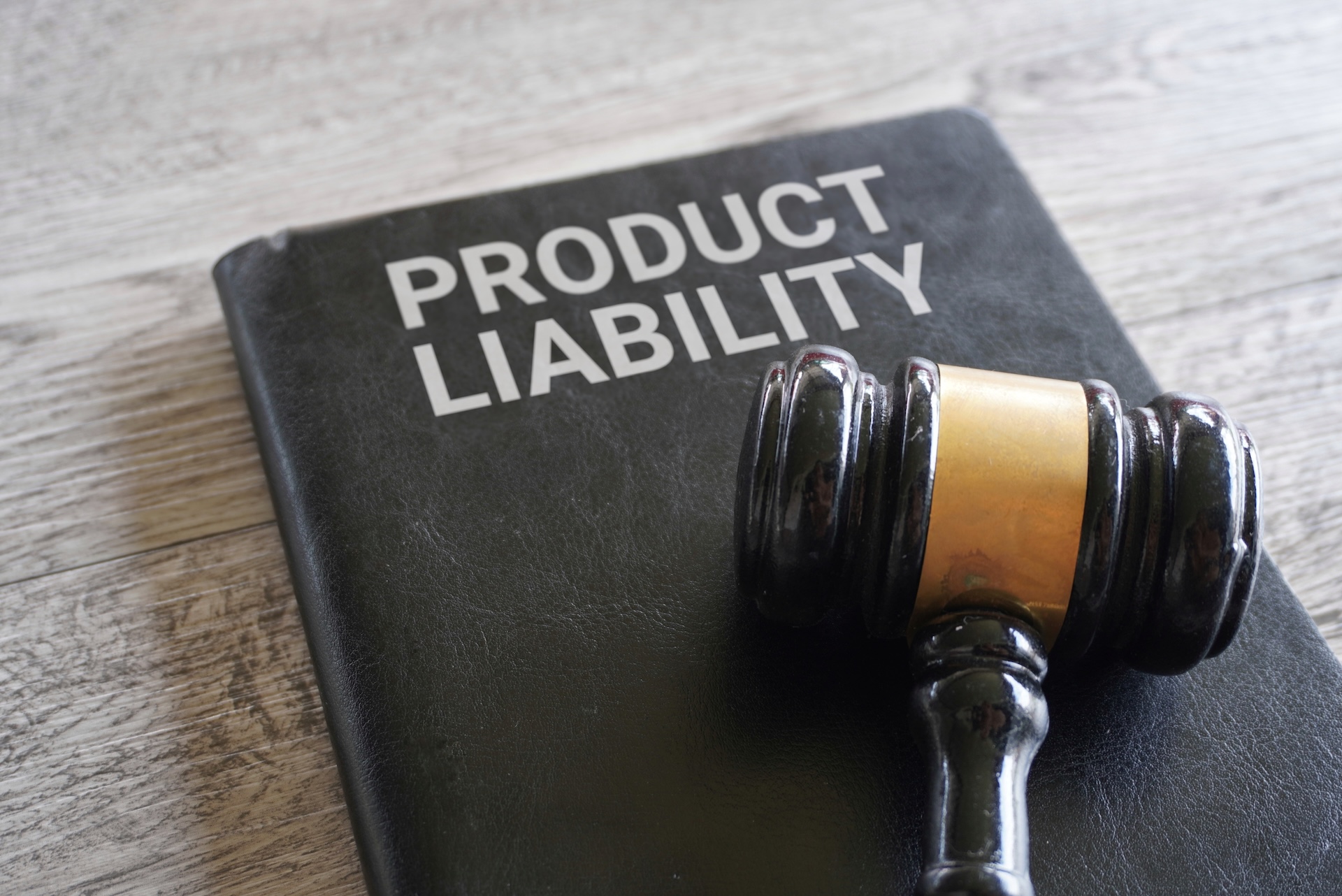 Closeup image of judge gavel and text product liability on table