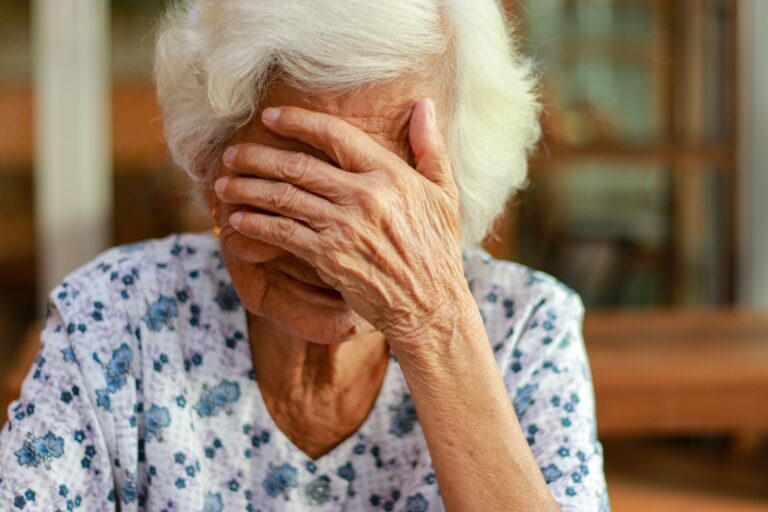 Upset elderly woman
