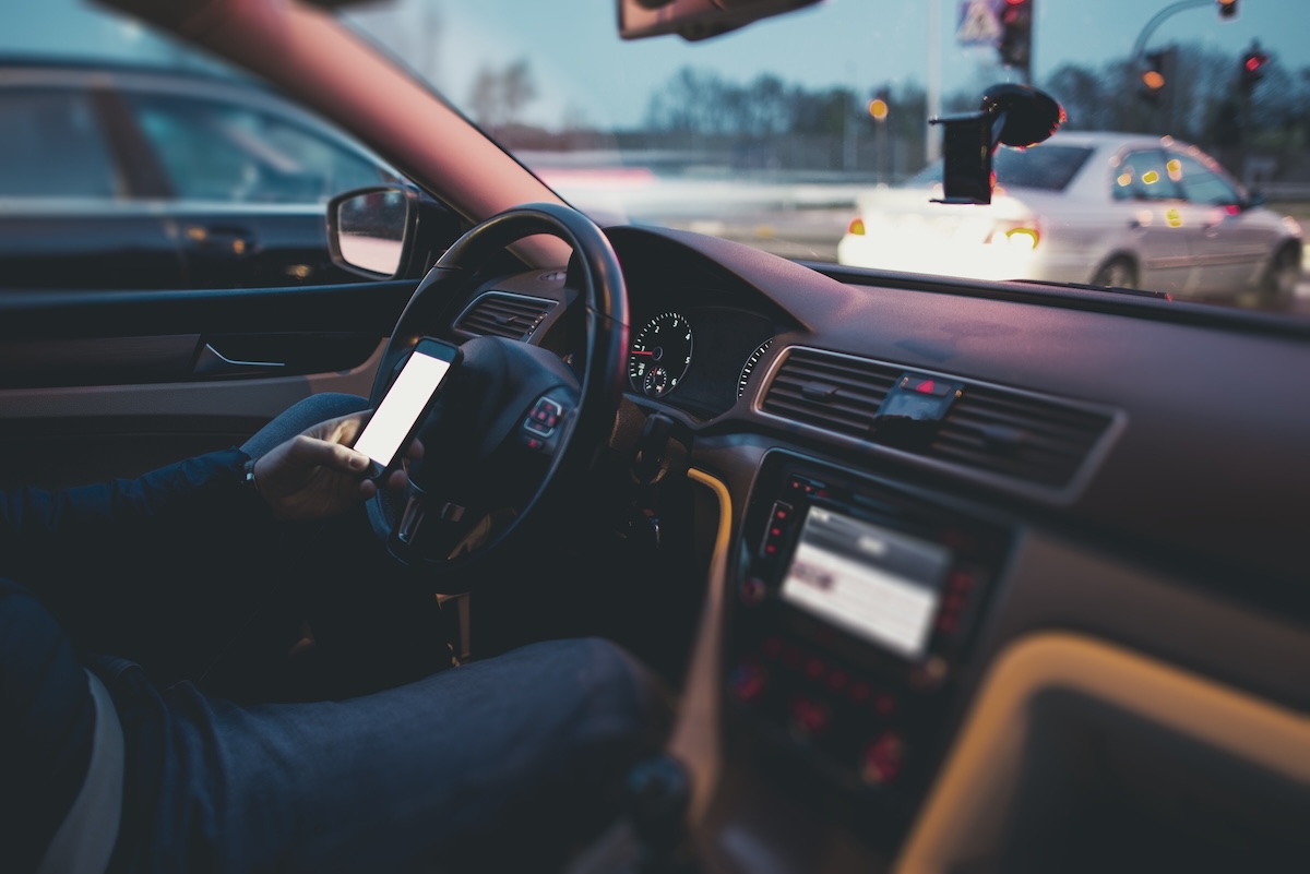 Distracted driver texting while in their car